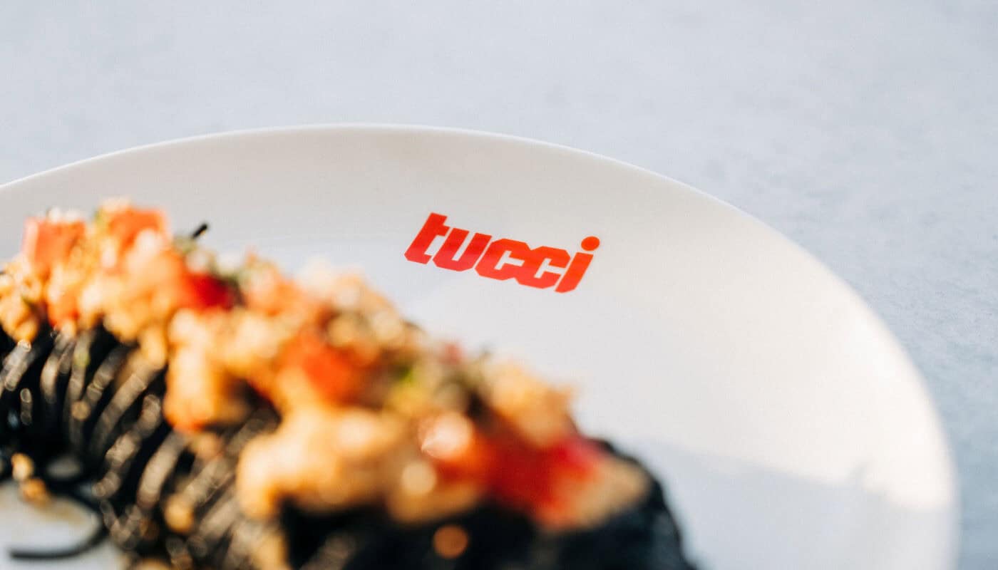a plate with tucci text